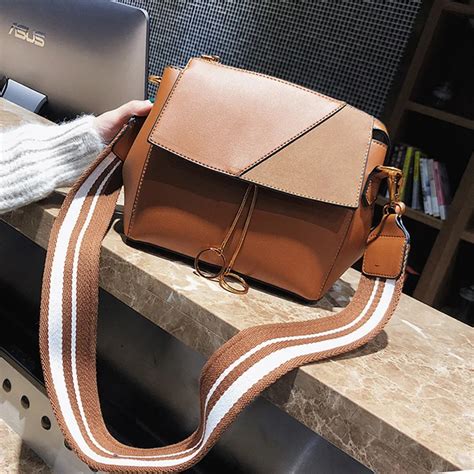 coach bag with thick strap.